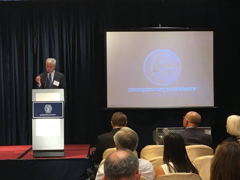 Delegation member and Chair of  Georgetown's Board of Directors Bill Doyle speaks during a panel discussion on  China's GreenTech Initiative in Hong Kong.