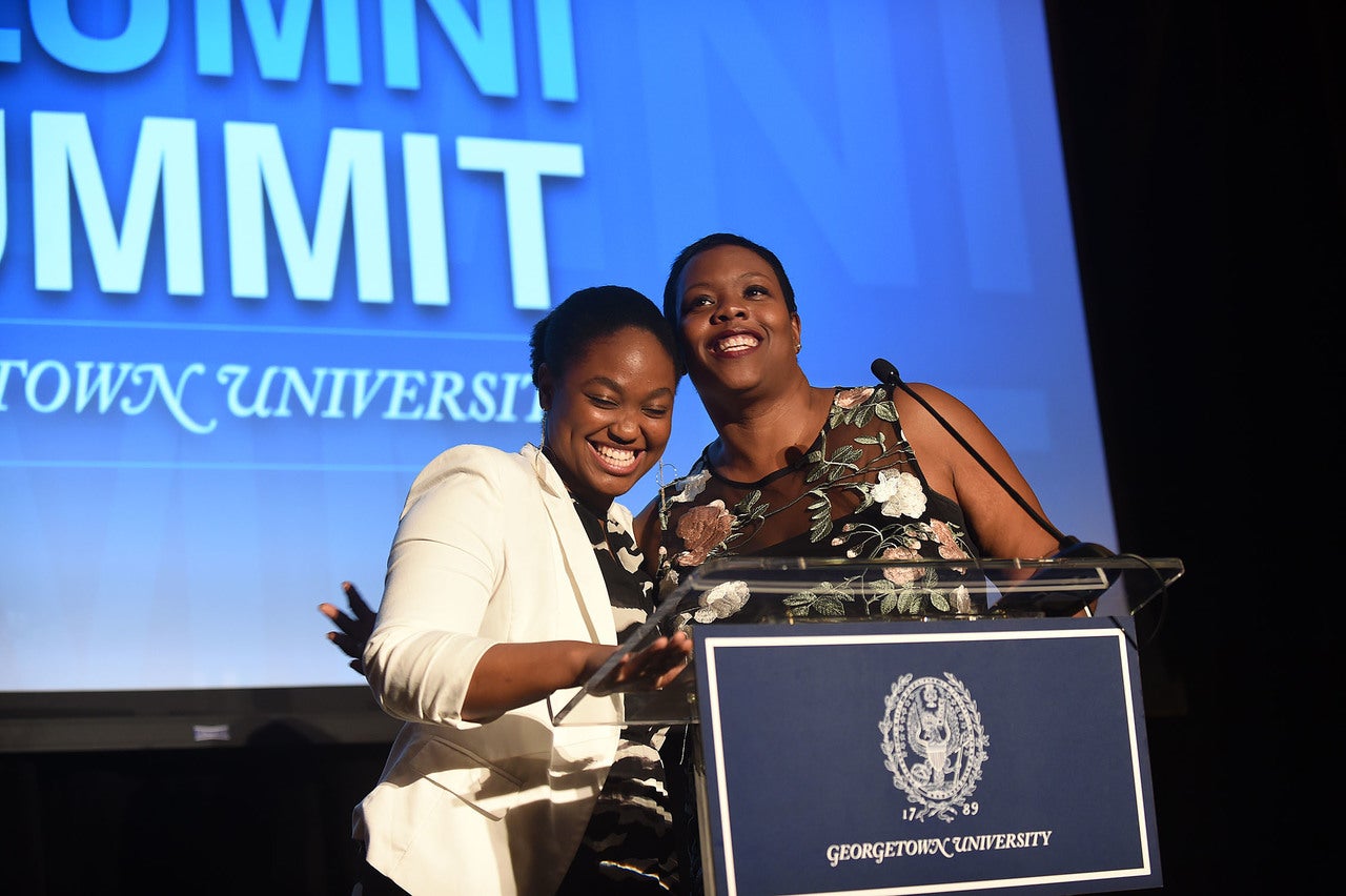 Elizabeth Nalunga and Kaya Henderson on stage at the Black Alumni Summit gala