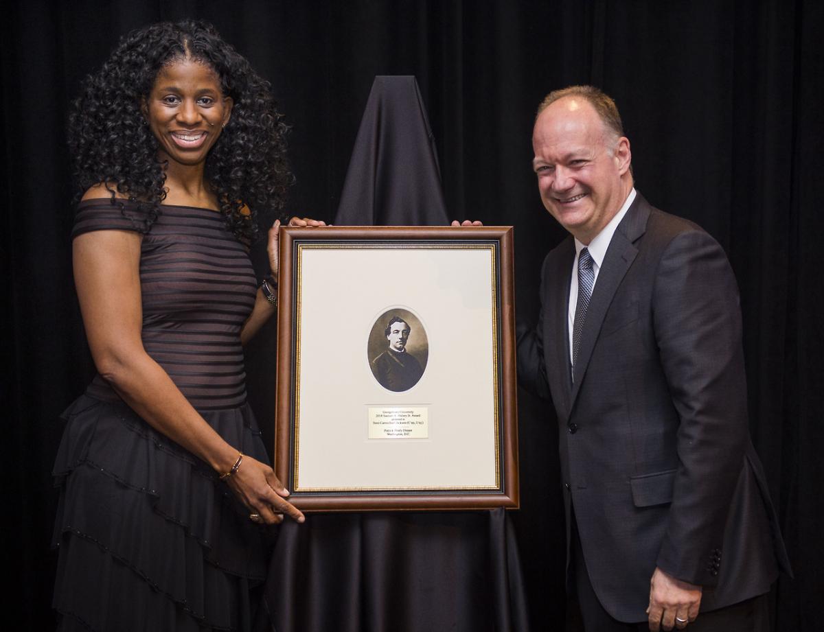 Terri Carmichael Jackson stands with President John J. DeGioia as she receives the Samuel A. Halsey Jr. Award