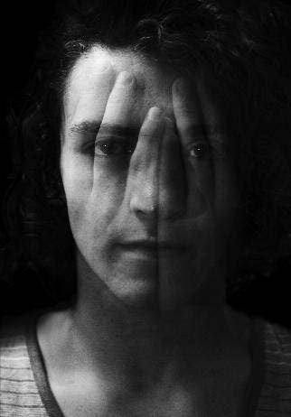 black and white photo of hands superimposed on a woman's face